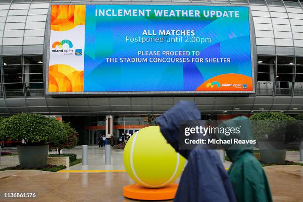 Fans walk through the tennis complex as matches are postponed on Day 2 of the Miami Open Presented by Itau on March 19, 2019 in Miami Gardens,...