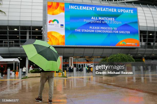 Fans walk through the tennis complex as matches are postponed on Day 2 of the Miami Open Presented by Itau on March 19, 2019 in Miami Gardens,...