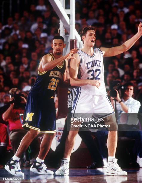University of Michigan forward Juwan Howard plays defense against Duke forward Christian Laettner during the NCAA Photos via Getty Images National...