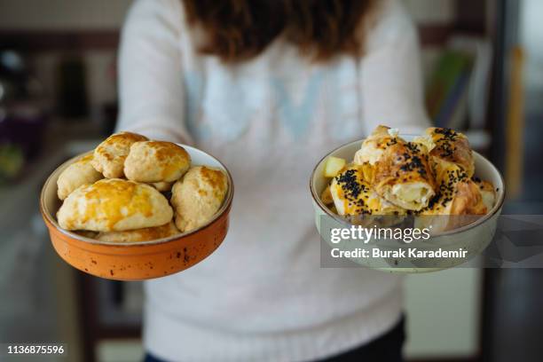 woman holds filled pastries in bowl and turkish patty, börek - blätterteigpastete stock-fotos und bilder