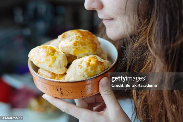 woman smells filled pastries in bowl - blätterteigpastete stock-fotos und bilder