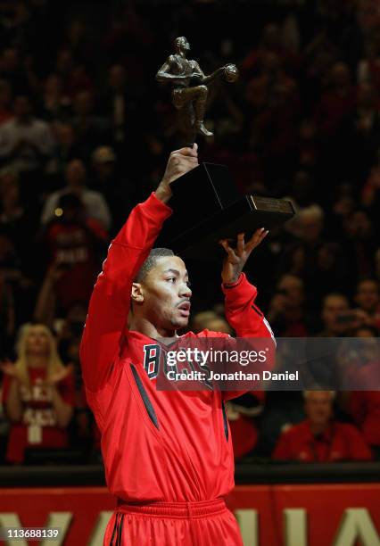 Derrick Rose of the Chicago Bulls holds up the Maurice Podoloff Trophy awarded to the NBA Most Valuable Player before taking on the Atlanta Hawks in...