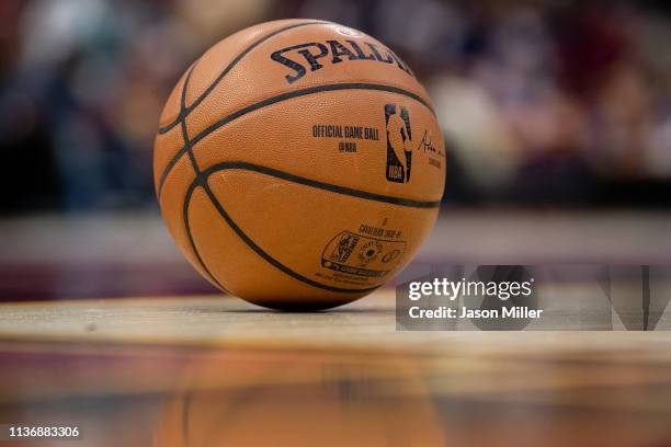 The official Spalding game basketball sits on the court between gameplay during the second half between the Cleveland Cavaliers and the Atlanta Hawks...