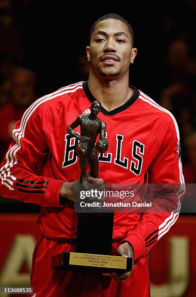 Derrick Rose of the Chicago Bulls holds the Maurice Podoloff Trophy awarded to the NBA Most Valuable Player before taking on the Atlanta Hawks in...