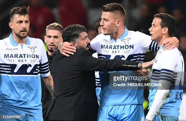 Milan's Italian coach Gennaro Gattuso and Lazio's Serbian midfielder Sergej Milinkovic-Savic intervene to put an end to a scuffle between Lazio's...