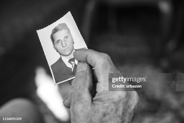 recalling youth - looking at old photo stock pictures, royalty-free photos & images