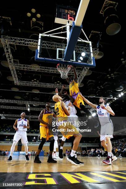 Ladarius Tabb of London Lions dunks the basketball over Ashley Hamilton of London City Royals during the British Basketball League game between...
