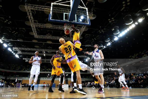 Ladarius Tabb of London Lions dunks the basketball over Ashley Hamilton of London City Royals during the British Basketball League game between...