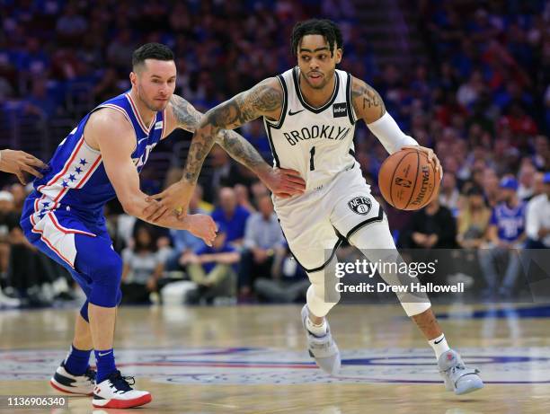 Angelo Russell of the Brooklyn Nets drives around JJ Redick of the Philadelphia 76ers in the first half during Game One of the first round of the...