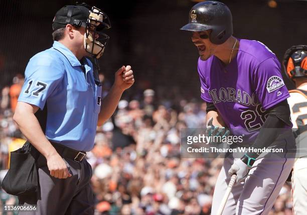Nolan Arenado of the Colorado Rockies argues with home plate umpire D.J. Reyburn after Arenado was called out on strikes against the San Francisco...