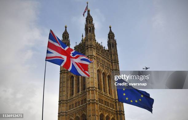 brexit flags outside parliament - brexit stock pictures, royalty-free photos & images