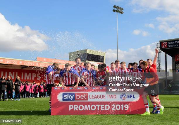 Lincoln City players celebrate after securing promotion following the Sky Bet League Two match between Lincoln City and Cheltenham Town at Sincil...