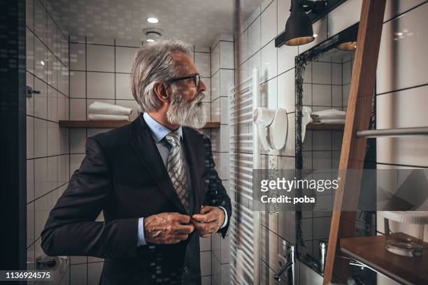 businessman dressing up - adjusting suit stock pictures, royalty-free photos & images