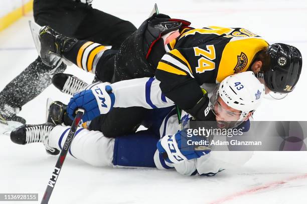 Jake DeBrusk of the Boston Bruins lands a punch on Nazem Kadri of the Toronto Maple Leafs in Game Two of the Eastern Conference First Round during...