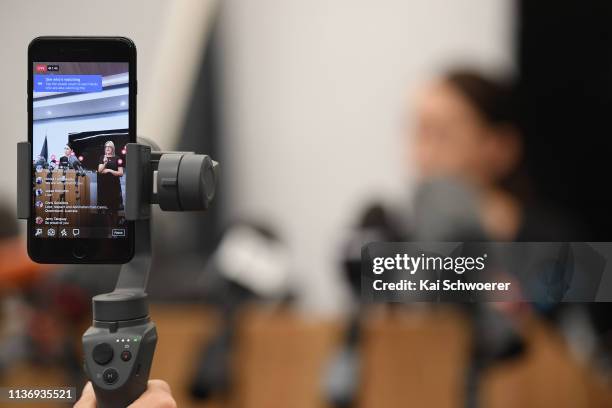 Facebook live video is seen as New Zealand Prime Minister Jacinda Ardern speaks to the media during a press conference at the Justice and Emergency...