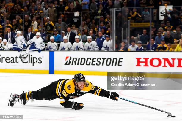 David Pastrnak of the Boston Bruins dives for a loose puck in yeti third period of a game against the Toronto Maple Leafs in Game Two of the Eastern...