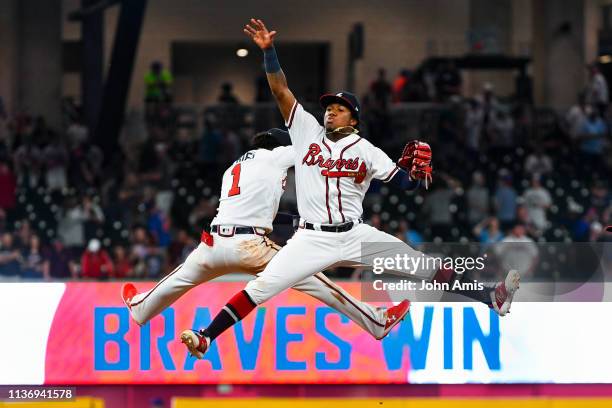 Ronald Acuna Jr. #13 and Ozzie Albies of the Atlanta Braves celebrate an 11-7 win over the New York Mets at SunTrust Park on April 13, 2019 in...