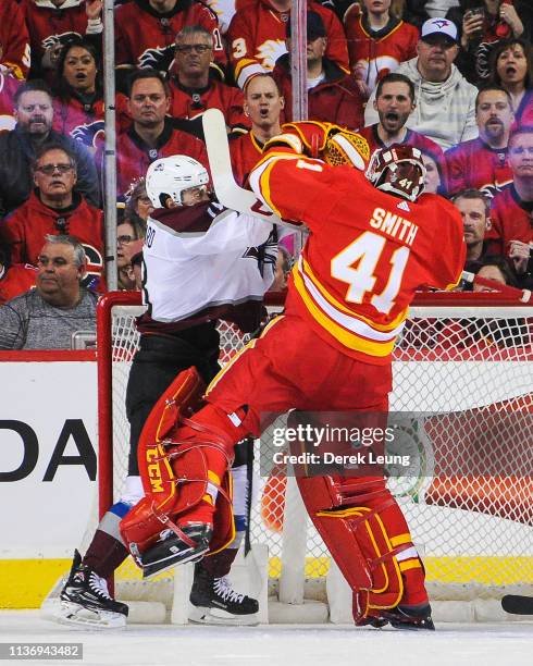 Mike Smith of the Calgary Flames fights Derick Brassard of the Colorado Avalanche during play in Game Two of the Western Conference First Round...