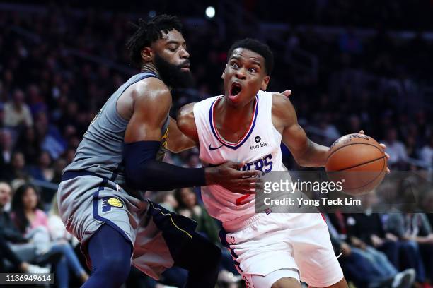 Shai Gilgeous-Alexander of the Los Angeles Clippers drives against Tyreke Evans of the Indiana Pacers during the fourth quarter at Staples Center on...