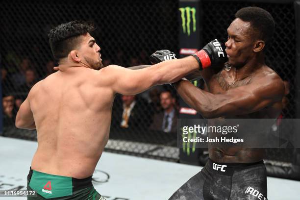 Kelvin Gastelum punches Israel Adesanya in their interim middleweight championship bout during the UFC 236 event at State Farm Arena on April 13,...
