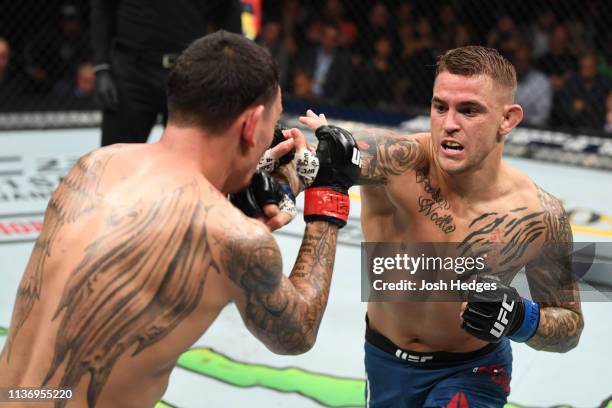 Dustin Poirier punches Max Holloway in their interim lightweight championship bout during the UFC 236 event at State Farm Arena on April 13, 2019 in...