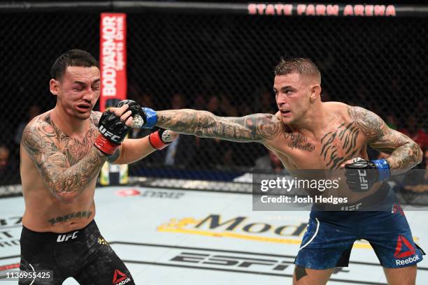 Dustin Poirier punches Max Holloway in their interim lightweight championship bout during the UFC 236 event at State Farm Arena on April 13, 2019 in...