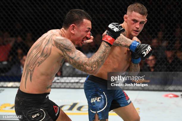 Dustin Poirier punches Max Holloway in their interim lightweight championship bout during the UFC 236 event at State Farm Arena on April 13, 2019 in...