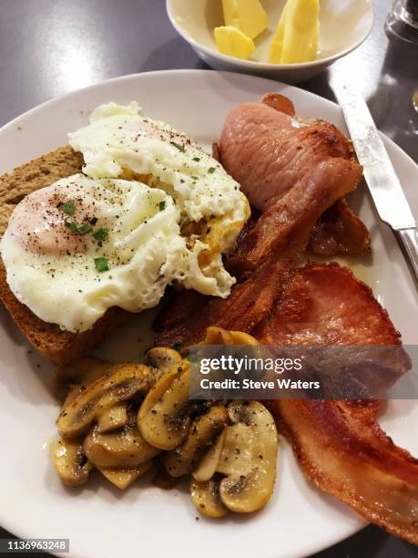 bacon & eggs, mushrooms, toast and butter on a plate. - clare valley south australia stock pictures, royalty-free photos & images