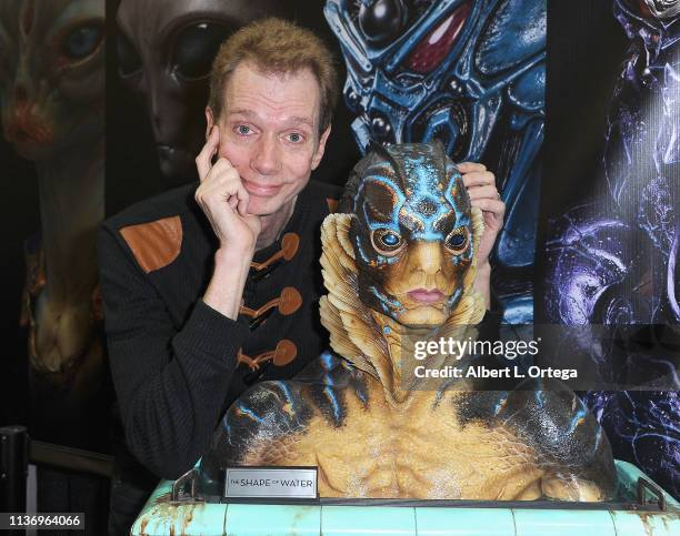 Doug Jones poses with the Gillman Bust from 'The Shape Of Water' at Elite Creature Collectibles Booth on day 2 of Monsterpalooza held at Pasadena...