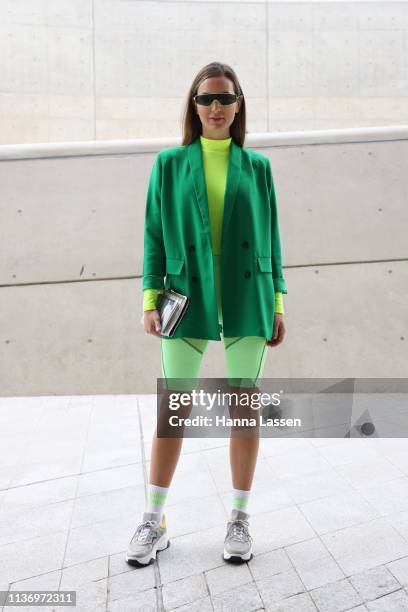 Guest wearing neon green sunglasses, bike shorts and sneakers is seen at the Hera Seoul Fashion Week 2019 F/W at Dongdaemun Design Plaza at...