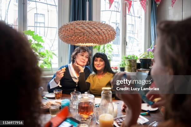 mixed group of women celebrating friend's birthday with a party - indian aunt stock pictures, royalty-free photos & images