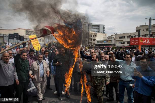 Iranians set ablaze a US flag during an anti-US rally following Friday prayers in Tehran on April 12 2019. The US government on 08 April 2019 said it...