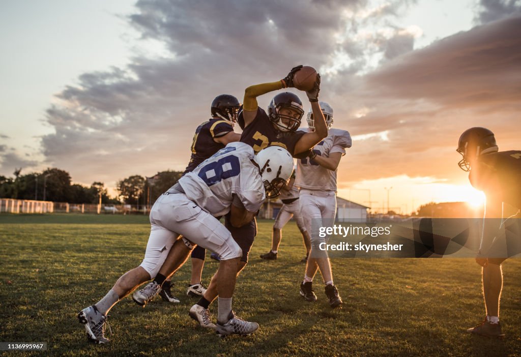 Tackling an offensive player at sunset!