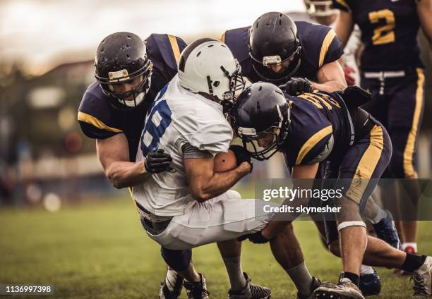 blocking an offensive player! - first down american football stock pictures, royalty-free photos & images