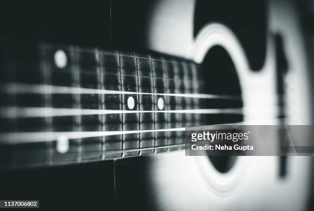 close up of an acoustic guitar - monochrome - classical music background stock-fotos und bilder