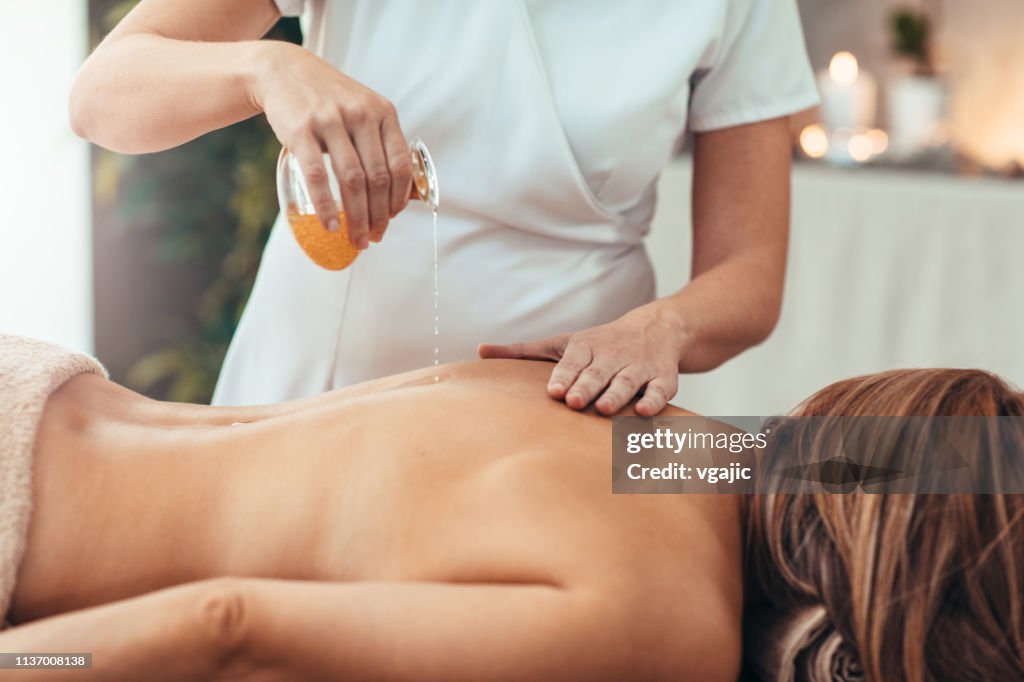 Kvinna njuta gyllene olje massage