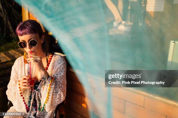 woman having a drink at beach bar - beach cocktail party stock pictures, royalty-free photos & images