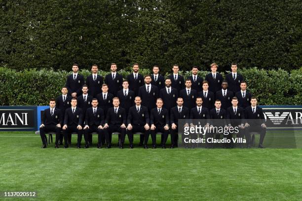 Players of Italy pose with staff members during Italy team photo with the new Armani suit at Centro Tecnico Federale di Coverciano on March 19, 2019...