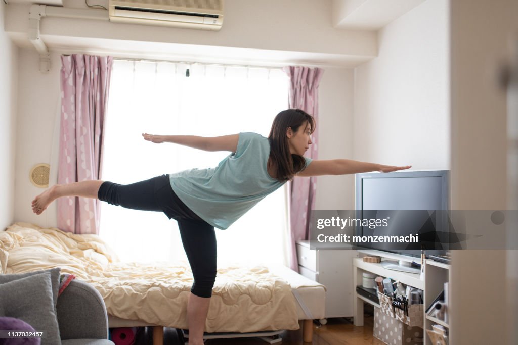Woman doing stretches on bed in the morning