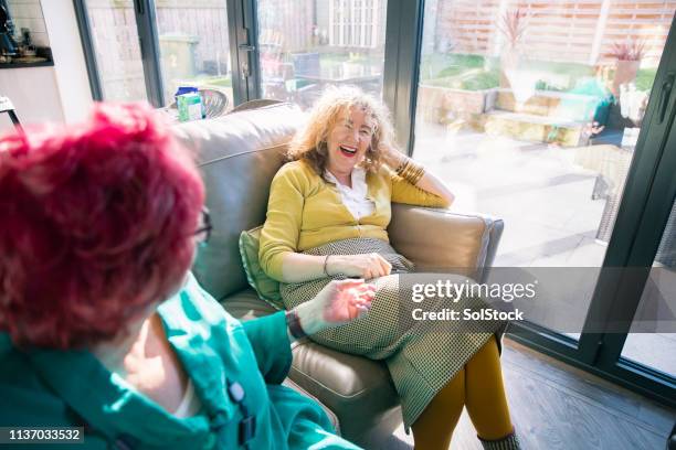 eccentric women relaxing together - coole oma stock-fotos und bilder