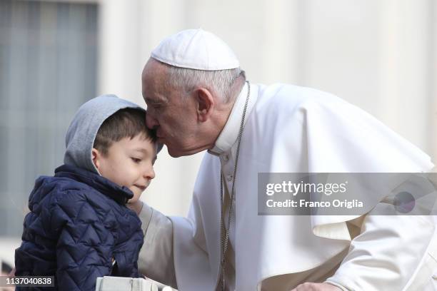 Pope Francis greets a boy as he arrives in St. Peter's Square for his weekly audience on March 20, 2019 in Vatican City, Vatican. During the general...