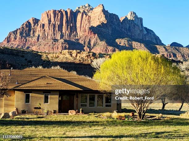 ranch house and new green leaves of spring on globe willow tree in rockville utah with zion national park in the background - utah house stock pictures, royalty-free photos & images