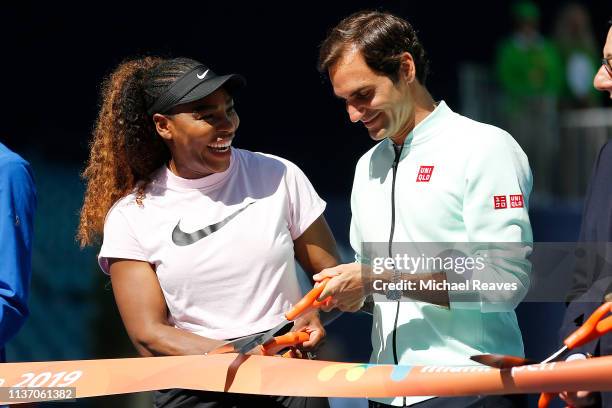 Serena Williams of the United States and Roger Federer of Switzerland cut the ribbon during the Ribbon Cutting ceremony on Day 3 of the Miami Open...