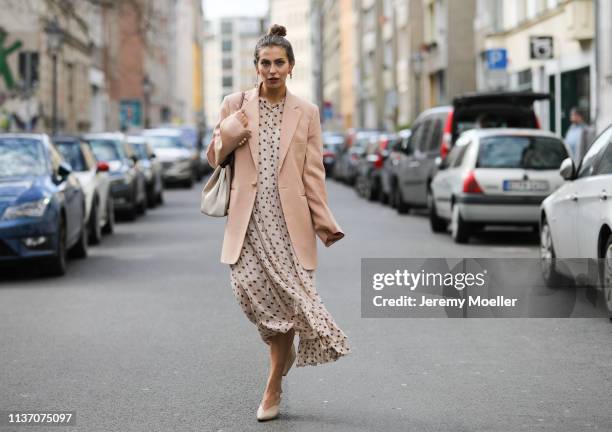 Masha Sedgwick wearing nude Baum und Pferdgarten maxi dress with dots and ruffles, oversized Joseph pink blazer, Tory Burch bucket bag, Maria Black...