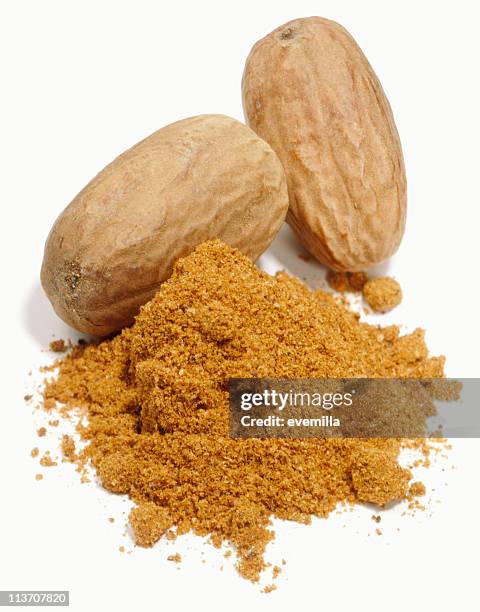 ground nutmeg on a white background - nutmeg stock pictures, royalty-free photos & images