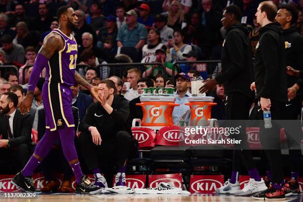 LeBron James of the Los Angeles Lakers high-fives his teammates during the first half of the game against the New York Knicks at Madison Square...