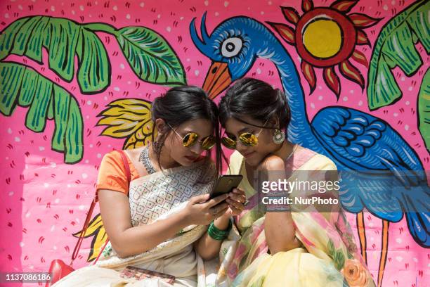 Bangladeshi woman pose for a portrait infront of wall paint to celebrate the first day of the Bengali New Year or Pohela Boishakh on April 14, 2019...
