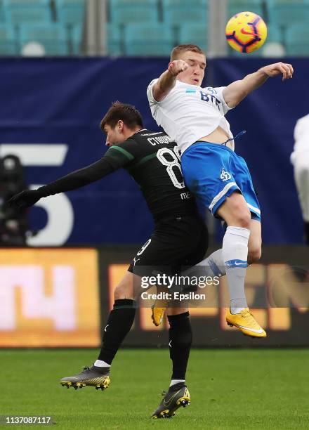 Evgeniy Lutsenko of FC Dinamo Moscow vies for the ball with Dmitriy Stotskiy of FC Krasnodar during the Russian Premier League match between FC...