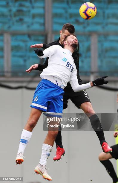 Evgeniy Markov of FC Dinamo Moscow vies for the ball with Aleksandr Zhirov of FC Krasnodar during the Russian Premier League match between FC Dinamo...