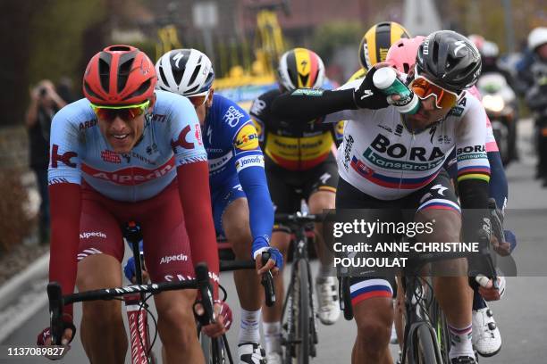 Slovakia's Peter Sagan drinks past Germany's Nils Politt as they lead during the 117th edition of the Paris-Roubaix one-day classic cycling race,...